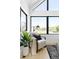Bright sitting area with stylish chair, black-framed windows, and view to outside at 2190 Vine Ave, Boulder, CO 80304