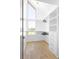 Bright walk-in closet featuring a window, white shelving, and light wood floors at 2190 Vine Ave, Boulder, CO 80304