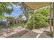 Backyard features a covered patio and is landscaped with bushes and trees, creating a private outdoor space at 2370 Redwood Ave, Lafayette, CO 80026
