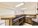 Finished basement bar area with sink, cabinets, counter, and ample shelving space at 2370 Redwood Ave, Lafayette, CO 80026