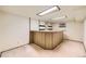Basement bar with built-in shelves, cabinets, and overhead lighting at 2370 Redwood Ave, Lafayette, CO 80026