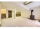 The finished basement features carpet, a wood-burning stove, and access to a basement bar at 2370 Redwood Ave, Lafayette, CO 80026
