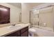Bathroom with shower-tub combo with glass doors and single sink vanity with mirror at 2370 Redwood Ave, Lafayette, CO 80026
