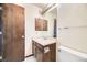 Bathroom featuring a single sink vanity, mirrored medicine cabinet, and a towel bar at 2370 Redwood Ave, Lafayette, CO 80026
