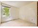 A simple, vacant bedroom with white walls, tiled floors, and a single window with natural light at 2370 Redwood Ave, Lafayette, CO 80026