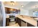 Open kitchen featuring dark cabinets, stainless steel appliances, and light countertops at 2370 Redwood Ave, Lafayette, CO 80026
