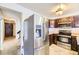 A partial view of the kitchen featuring stainless steel appliances and dark wood cabinets at 2370 Redwood Ave, Lafayette, CO 80026