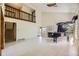 Bright living room featuring soaring ceilings, tile floors, a black baby grand piano, fireplace and a second story balcony at 2370 Redwood Ave, Lafayette, CO 80026