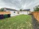 A well-manicured backyard featuring a lush lawn and a charming fence at 1694 Xanthia St, Denver, CO 80220