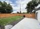 Large backyard features a well-maintained lawn, concrete patio, and privacy fencing at 1694 Xanthia St, Denver, CO 80220