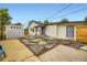 Charming backyard showcasing a detached garage and stepping stone pathway at 1694 Xanthia St, Denver, CO 80220