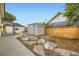 Landscaped backyard showcasing a shed, stepping stones, and privacy fencing at 1694 Xanthia St, Denver, CO 80220