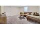 Finished basement area with comfortable seating, modern furniture, and neutral carpeting at 1694 Xanthia St, Denver, CO 80220