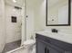 Bathroom with marble tile shower, modern vanity, and matte black hardware at 1694 Xanthia St, Denver, CO 80220