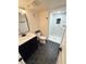 Modern bathroom featuring a navy blue vanity and walk-in shower with black hardware and hexagon tile flooring at 1694 Xanthia St, Denver, CO 80220