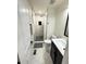 Bathroom with walk-in shower and updated vanity at 1694 Xanthia St, Denver, CO 80220