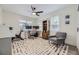 Bedroom featuring a ceiling fan, bright windows, and hardwood floors with a colorful rug at 1694 Xanthia St, Denver, CO 80220