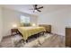 Bright bedroom with a large window and ample natural light, featuring light wood floors at 1694 Xanthia St, Denver, CO 80220
