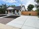 Exterior view showcasing the home's front yard, driveway, landscaping, and charming curb appeal at 1694 Xanthia St, Denver, CO 80220