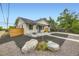 Charming bungalow with new landscaping, painted brick, inviting porch, and contemporary design elements at 1694 Xanthia St, Denver, CO 80220