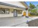 Inviting front porch of this well-kept home features a painted porch and a secure ADT security sign at 1694 Xanthia St, Denver, CO 80220