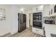 Modern kitchen with stainless steel appliances, sleek cabinets, and elegant tile backsplash at 1694 Xanthia St, Denver, CO 80220
