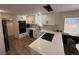 Modern kitchen featuring white cabinets, quartz countertops, stainless steel appliances, and stylish backsplash at 1694 Xanthia St, Denver, CO 80220