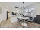 Eat-in kitchen with modern lighting, stainless appliances, breakfast bar, and ample counter space at 1694 Xanthia St, Denver, CO 80220