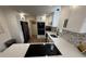 Updated kitchen with white cabinets, sleek appliances, and modern finishes for a clean and stylish design at 1694 Xanthia St, Denver, CO 80220
