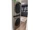 Modern laundry area with stacked washer and dryer and closet at 1694 Xanthia St, Denver, CO 80220