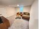 Basement Gathering room with plush carpeting, an updated window and comfortable, modern furniture at 1694 Xanthia St, Denver, CO 80220