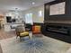 Open living space featuring fireplace, stylish furniture, and seamlessly connected to modern kitchen at 1694 Xanthia St, Denver, CO 80220