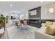 Inviting living space featuring a cozy fireplace and seamless flow into the modern kitchen at 1694 Xanthia St, Denver, CO 80220