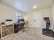 Neutral office space featuring carpet flooring, a desk and chair, an exercise bike, and natural light at 1694 Xanthia St, Denver, CO 80220