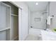 Bright modern bathroom features a shower and tub combo, and closet for storage at 1075 S Garrison St # 201, Lakewood, CO 80226
