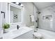 This bathroom is modern and bright with sleek fixtures and tiled shower at 1075 S Garrison St # 201, Lakewood, CO 80226