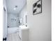Bathroom features a modern vanity with a shower and tub combo with tiled walls at 1075 S Garrison St # 201, Lakewood, CO 80226