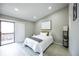 This bedroom features a private balcony door and recessed lighting at 1075 S Garrison St # 201, Lakewood, CO 80226