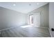 Bright bedroom with light wood flooring, sliding glass doors, and neutral walls at 1075 S Garrison St # 201, Lakewood, CO 80226