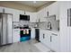 Updated kitchen with white cabinets, stainless steel appliances, and modern finishes at 1075 S Garrison St # 201, Lakewood, CO 80226