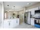 Bright, renovated kitchen with stainless steel appliances and light gray flooring open to the living area at 1075 S Garrison St # 201, Lakewood, CO 80226