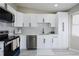 A beautifully renovated kitchen with white cabinets, stainless steel appliances, and a modern backsplash at 1075 S Garrison St # 201, Lakewood, CO 80226