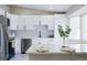 Renovated kitchen boasts white cabinets, quartz counters, and stainless steel appliances at 1075 S Garrison St # 201, Lakewood, CO 80226
