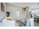 Spacious living room with open floor plan to the kitchen, neutral color scheme, and modern lighting at 1075 S Garrison St # 201, Lakewood, CO 80226