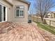 Beautiful backyard patio with brick pavers, ideal for outdoor entertaining and relaxation at 10674 Cherrington St, Highlands Ranch, CO 80126