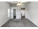 Neutral bedroom with carpet, ceiling fan, closet and entryway to en-suite bathroom at 10674 Cherrington St, Highlands Ranch, CO 80126