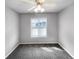 This bedroom is carpeted and has a ceiling fan and window at 10674 Cherrington St, Highlands Ranch, CO 80126