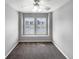 This bedroom is carpeted and has a ceiling fan and a large window at 10674 Cherrington St, Highlands Ranch, CO 80126