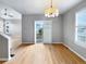 Bright dining room with hardwood floors, stylish chandelier, and sliding glass door at 10674 Cherrington St, Highlands Ranch, CO 80126