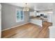 Open floor plan with dining area and kitchen featuring hardwood floors and natural light at 10674 Cherrington St, Highlands Ranch, CO 80126